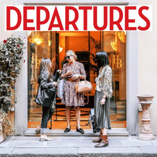 Three women standing in front of a store entrance.